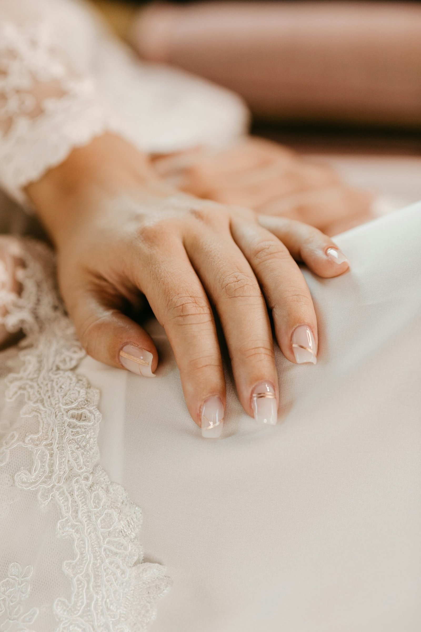 a close up of a person's hands on a bed